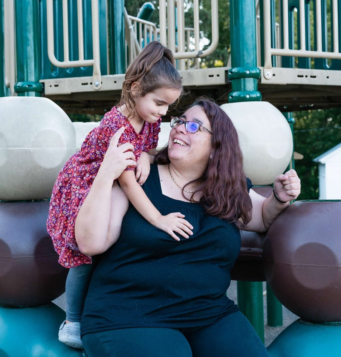 Woman with daughter playing on playground