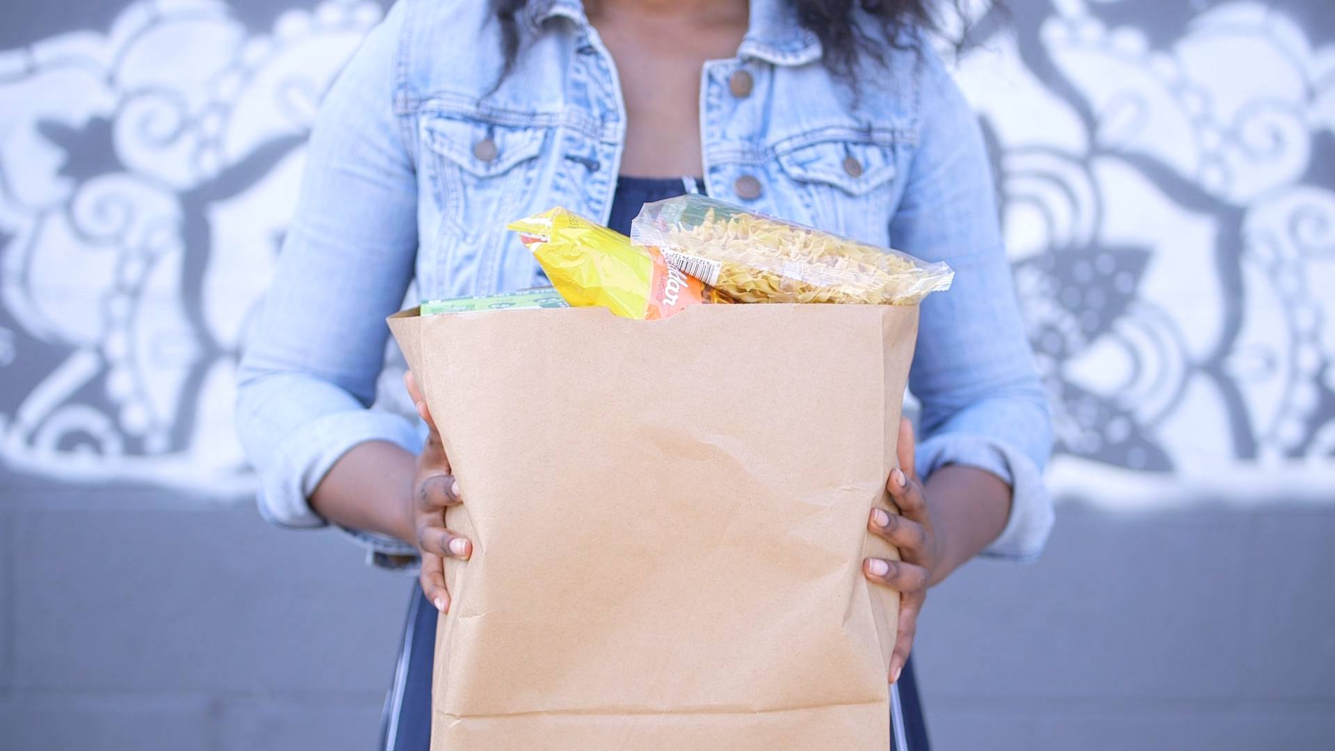 Angel holding a bag of groceries