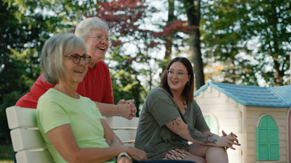 mom laughing with two neighboring volunteers